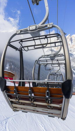 Empty Chairlift Ascending Over Snowy Ski Slopes with Mountain Views, Winter Sports and Recreationの素材