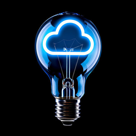 Cloud Computing Concept Illuminated Light Bulb with Glowing Cloud Symbol on Black Backgroundの素材