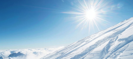 Sun Shining Over Snow Covered Mountain Slope Against Bright Blue Sky, Winter Landscape.の素材