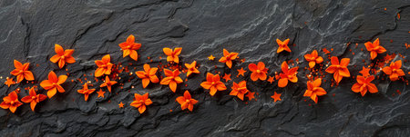 Vibrant Orange Paper Flowers and Sparkles on Rustic Black Slate, Flat Lay Background with Copy Spaceの素材