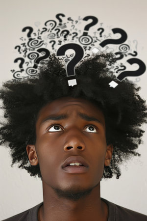 Confused Young Man with Question Marks. Searching for Answers, Problem Solving Concept.の素材
