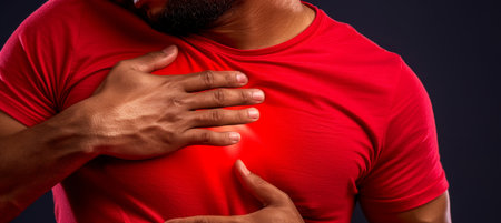 Man Suffers From Chest Pain On Black Background, Holding His Chest In Pain Man having Heart Attackの素材