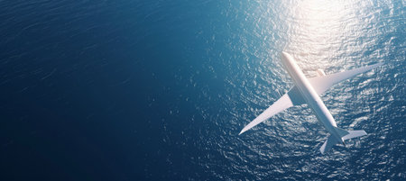White Passenger Airplane Soaring Over Deep Blue Ocean Waters on a Sunny Day, Aerial Viewの素材