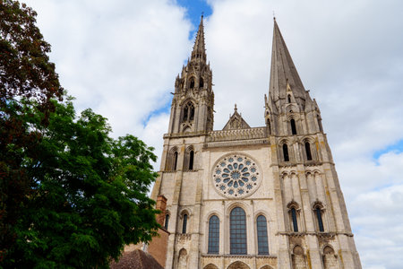 Chartres, France. Cathedral with two tall spires and a large rose window in the center of the facade