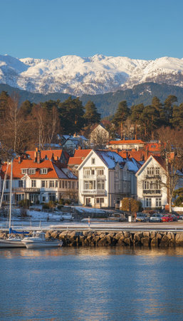 Scenic Norwegian Coastal Village Traditional Houses with Snow-Capped Mountains, Fjord Landscapeの素材