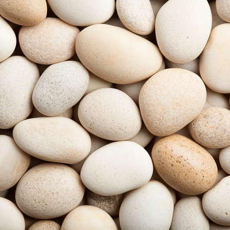 Smooth, Round Beige Pebbles Background A Close Up of Soft Stones in a Neutral Paletteの素材