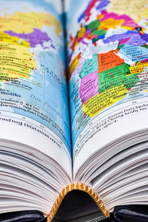 Open Atlas With Colorful Map of Europe, Close-Up Perspective Highlighting Geography Conceptsの素材
