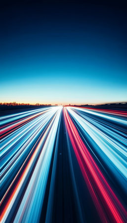 Abstract. Colorful light streaks on a road at night with a bright horizon, evoking speed and motion.の素材