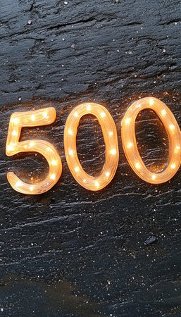 Lighted Number 500 Sign On Rustic Background. Concept Of Anniversary, Followers, Celebration.の素材