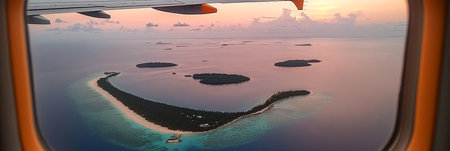 Aerial Sunset View of a Tropical Island Chain Through an Airplane Window, Travel Destinationの素材