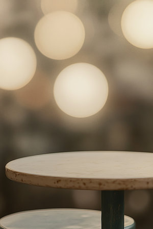 Modern Minimalist Cafe Interior with Empty Round Table and Blurred Bokeh Lights Backgroundの素材