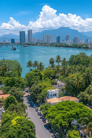Coastal Cityscape Modern Buildings, Lush Greenery, Mountains, and Tranquil Blue Watersの素材