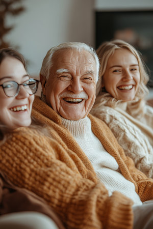 Happy Family Portrait Senior Man Sharing Laughter And Joy With Young Women On A Cozy Couchの素材