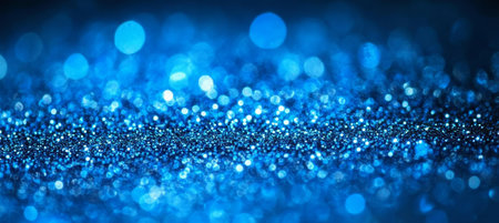 Abstract blue glitter background with bokeh effect, sparkling and festive holiday texture.の素材