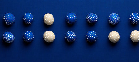 Patterned Easter Eggs in Blue and White on a Blue Background Festive Spring Celebrationの素材