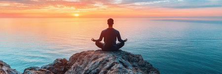 Man Meditating on Clifftop at Sunset, Embracing Tranquility and Mindfulness by the Oceanの素材