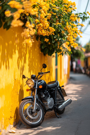 Vintage Motorcycle against Vibrant Yellow Wall, Capturing the Charm of Hoi An Old Town, Vietnamの素材