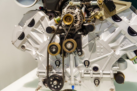 Munich, Germany, 16.07.2024 - Close-up of a car engine featuring belts and pulleys in detail