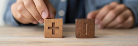 Decision Making Process Close Up of Mans Hand Placing Plus and Minus Sign Wooden Cubesの素材
