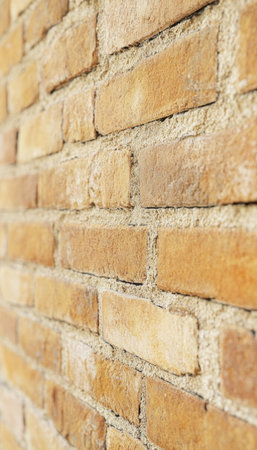 Yellow Brick Wall Background. Texture of Yellow Clay Brick Wall. Building Facade. Close up.の素材