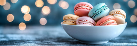 Assortment of Colorful French Macarons in a White Bowl Against a Festive Bokeh Background.の素材