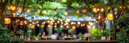 Idyllic outdoor gathering spot in the evening with soft fairy lights for text overlay.の素材