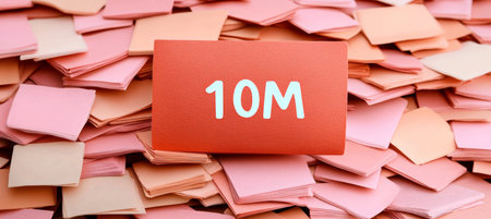 Red Note With Text 10M , Symbolizing A Milestone Achievement With Soft Pastel Notes Backgroundの素材