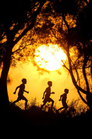 Golden Hour Fun Silhouetted Children Running Through Field at Sunset, with Copy Spaceの素材