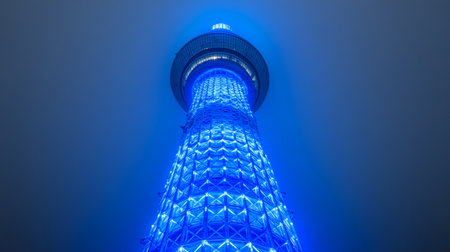 Tokyo Skytree Tower Illuminated in Dazzling Blue Lights, Architectural Landmark at Night, Japan.の素材