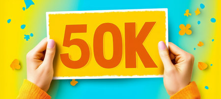 Celebrating 50K Achievement Hands Hold Bright Sign Against a Festive, Colorful Backgroundの素材