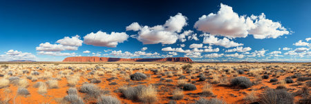 Scenic Desert Landscape Uluru Under a Blue Sky in Northern Territory, Australia - daytimeの素材