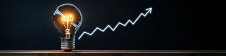 Glowing Light Bulb and Upward Arrow Chart Illustrating Rising Electricity and Energy Costsの素材