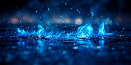 Vibrant Blue Flames Dance on Reflective Dark Background, Providing Dramatic Copy Space for Designs.の素材
