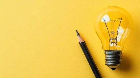 Think Big Ideas Inspiration for Business With a Lightbulb, Pencil, and Copy Space On Yellowの素材