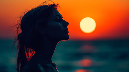 Serene Sunrise Silhouette Woman Finds Inner Peace with Ocean Meditation at Vibrant Dawnの素材