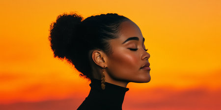 Golden Hour Serenity Profile Portrait of a Young Black Woman Embracing the Tranquility of Sunsetの素材