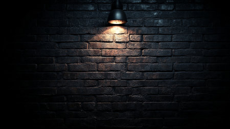 Dark Gray Brick Wall With Single Light Source For Texture, Background Or Wallpaper With Copy Spaceの素材