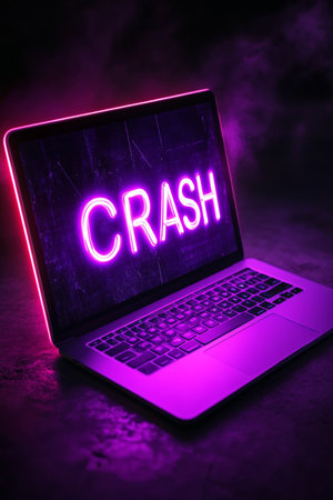 Laptop Computer With Glowing Neon Crash Text On Screen Illustrating Technology Crash Conceptの素材