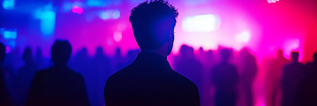 Man At Music Event, Stage Lights, And Blurry Crowd Silhouette. Copy Space For Text Placement.の素材