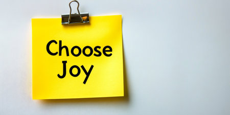 Yellow Sticky Note with Choose Joy Text on a White Background, Minimalist Concept of Happinessの素材