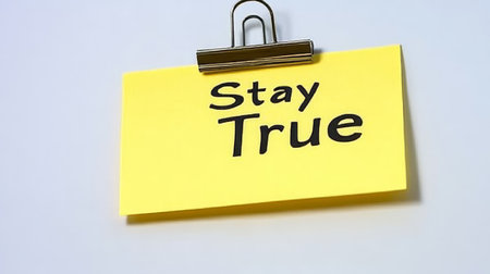 Yellow Sticky Note With Stay True Motivation Quote Message On Textured White Background.の素材