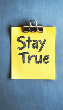 Stay True Note. Yellow Sticky Note With Motivational Message On Blue Background. Reminder Concept.の素材