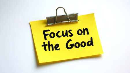 Yellow Sticky Note With Paperclip And Motivational Quote, Focus On The Good, On White Backgroundの素材