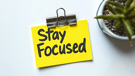 Yellow Sticky Note With Stay Focused Motivation Message, Clip, White Background, Office Suppliesの素材