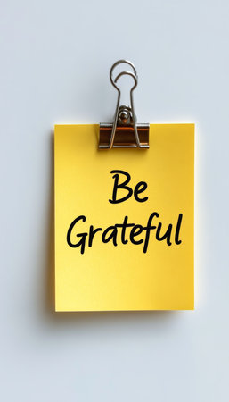 Yellow Sticky Note, Reminder or Encouragement Message Be Grateful on White Backgroundの素材