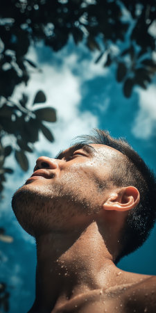 Young Man Enjoying Fresh Air in Nature, Portrait of Serenity and Connection with Natural Environmentの素材