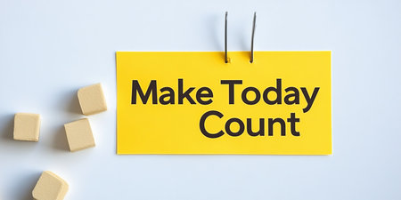 Make Today Count Yellow Sticky Note with Motivational Text and Wooden Cubes on White Backgroundの素材