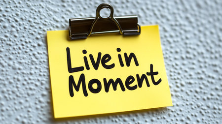 Live in Moment Reminder Note, Mindfulness Concept, Yellow Sticky Note on Textured Backgroundの素材