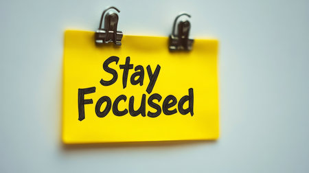 Stay Focused Reminder. Yellow Sticky Note With Motivational Message On White Background.の素材