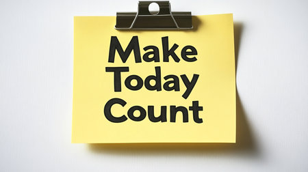 Make Today Count, Motivational Message on a Yellow Sticky Note Clipped to a White Backgroundの素材